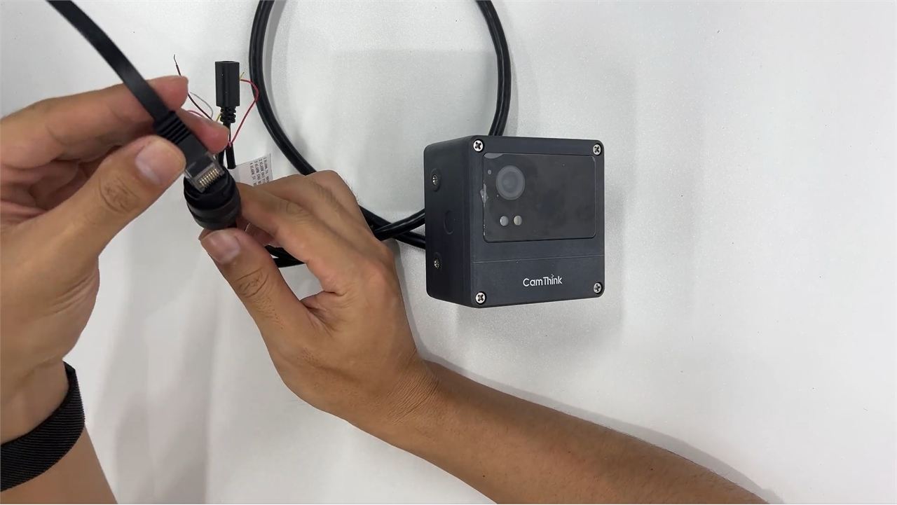 Ethernet cable being connected to the NeoEyes NE301 PoE adapter
