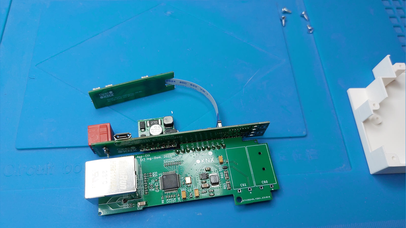 The Ethernet application board seated above the REG1 controller board, with a flat ribbon cable running to the front panel PCB and the RJ45 jack overhanging the left edge