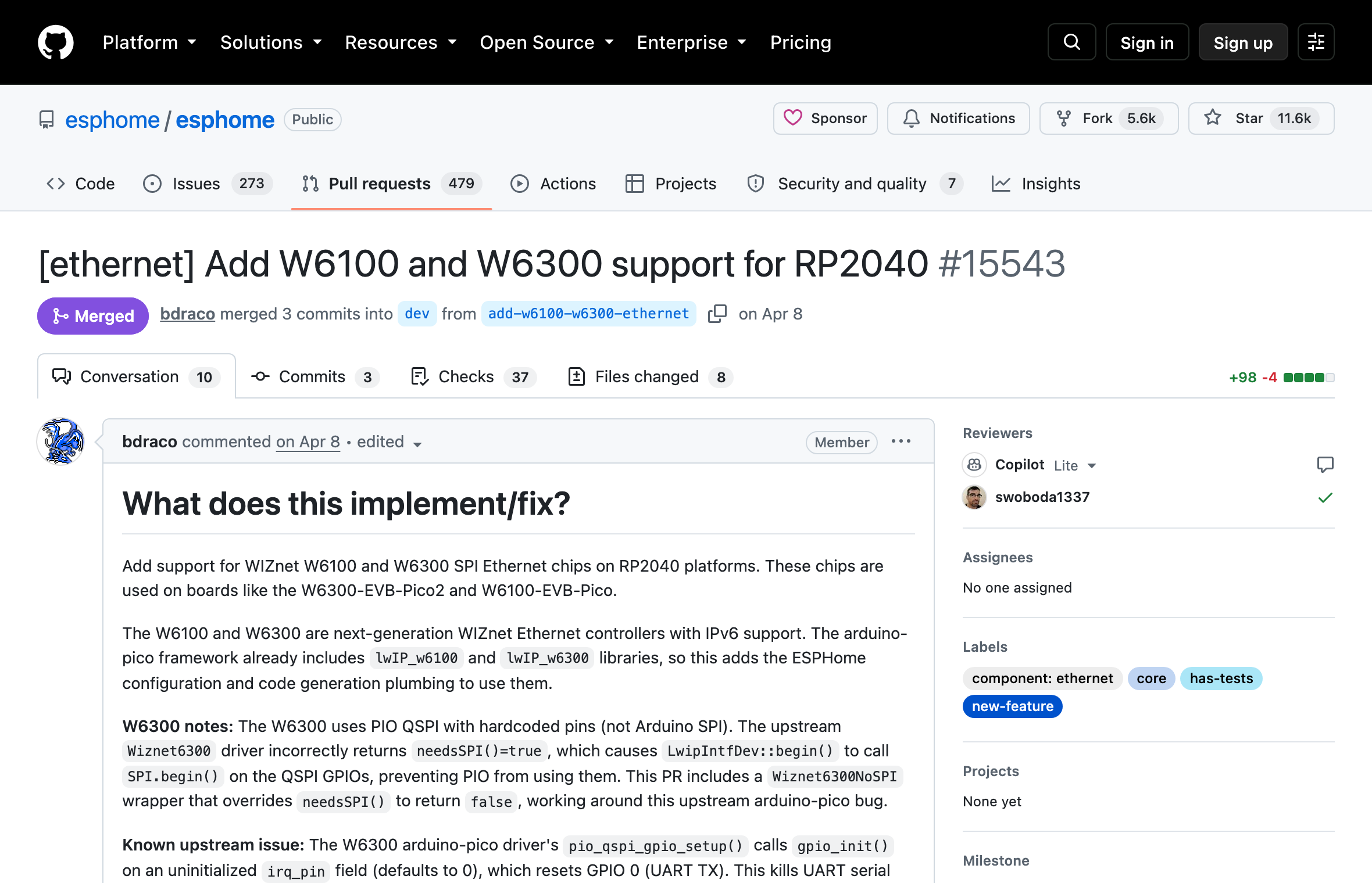 Screenshot of the merged GitHub pull request 15543, titled Add W6100 and W6300 support for RP2040, showing the merged badge, the 98 added lines, and the opening paragraphs that explain the PIO QSPI workaround