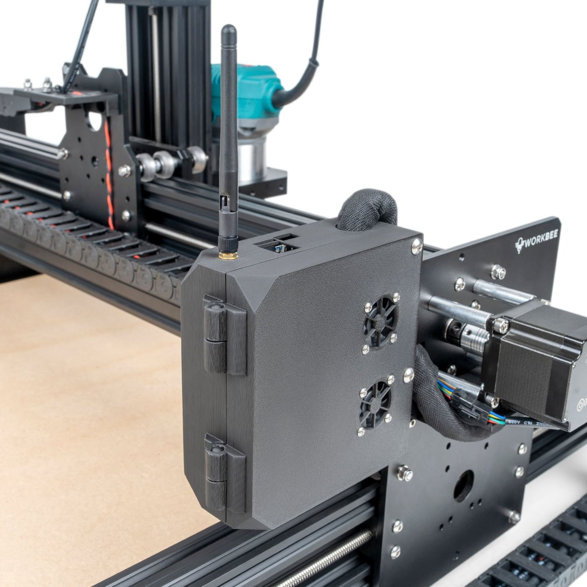 Close-up of the current WorkBee controller case mounted on the machine gantry, a black hinged enclosure with a Wi-Fi antenna, cooling fan grilles and a cable loom