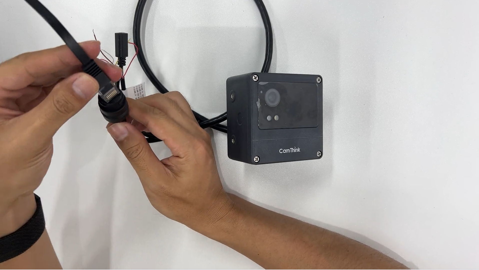 Ethernet cable being connected to the NeoEyes NE301 PoE adapter