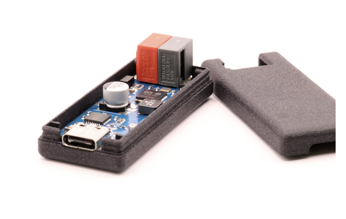 Photo of the TUL board sitting in its open plastic enclosure, with the lid removed and the red and grey KNX terminals visible at the top