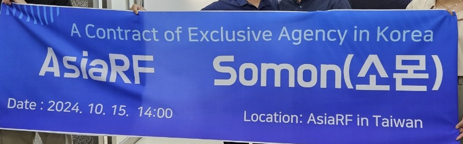 Photograph of a printed blue banner reading A Contract of Exclusive Agency in Korea, AsiaRF, Somon, Date 2024. 10. 15. 14:00, Location AsiaRF in Taiwan, held up by several people