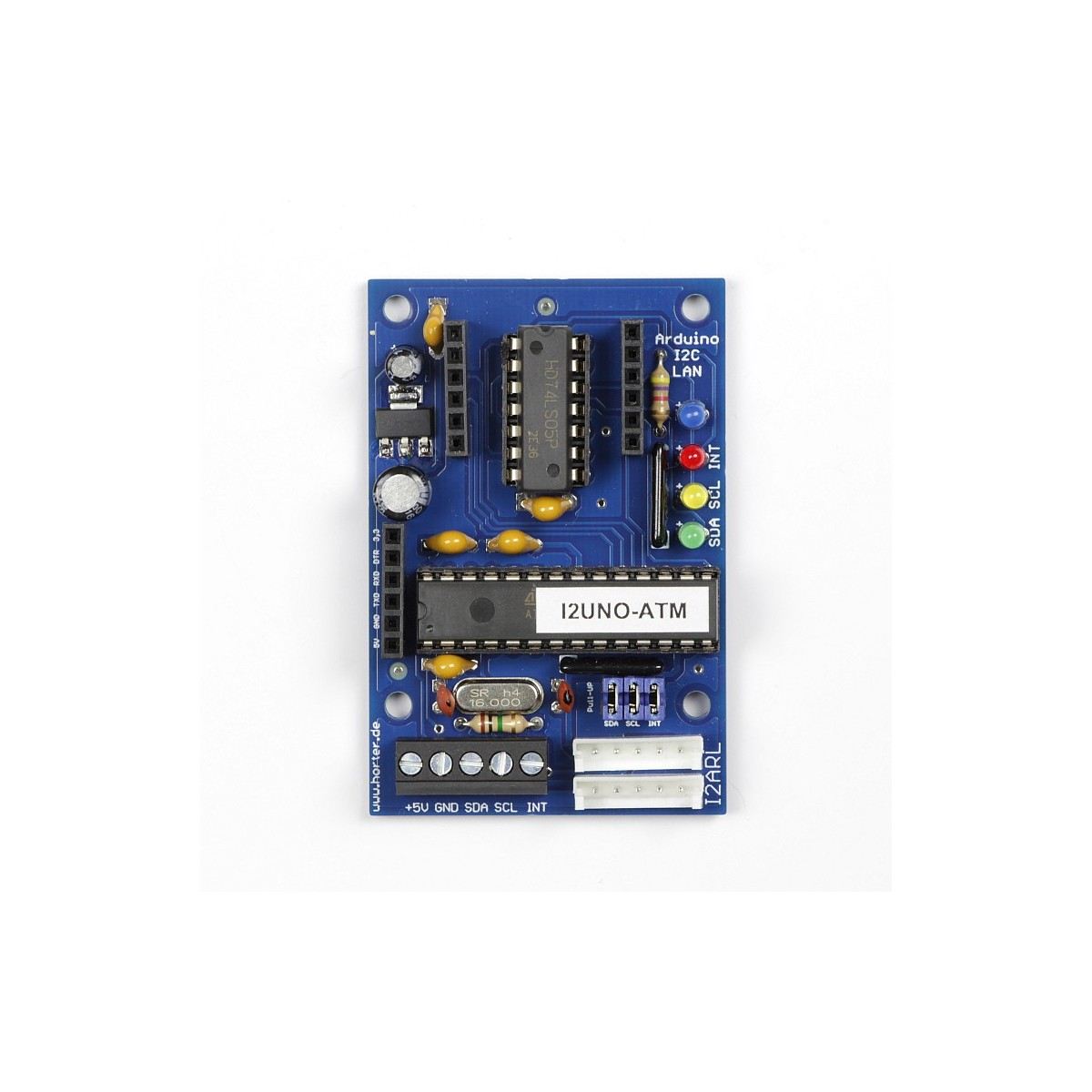 Top view of an assembled Horter I2ARL board photographed on white, showing a 28-pin DIP microcontroller labelled I2UNO-ATM, a 74LS05 inverter, a 16 MHz crystal, three empty black six-pin socket strips, a five-pole screw terminal marked plus 5V GND SDA SCL INT, two white bus connectors and four LEDs